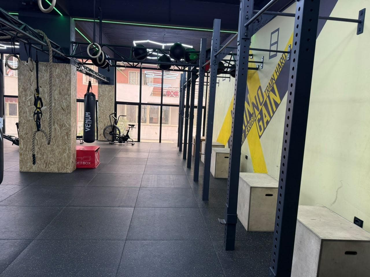A training rig and punching bag along the corridor leading to the crossfit wall